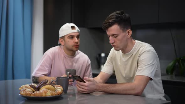 Side View Absorbed Young Gay Man Messaging Online on Smartphone As Boyfriend Talking Waving at