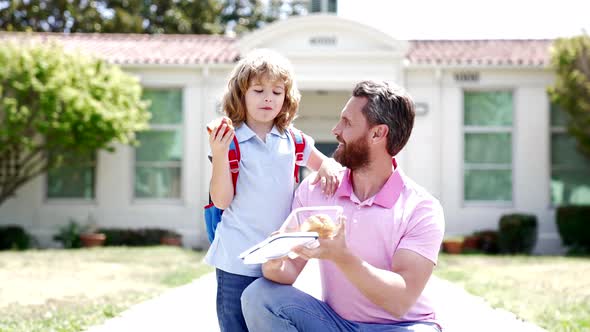 Happy Man Teacher Hold Food for Boy Pupil Outside the School Slow Motion Fathership