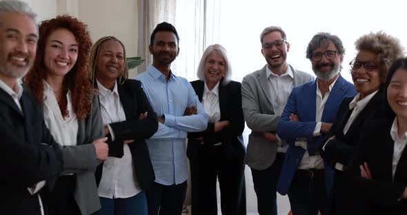 Multiracial business people looking at camera inside bank office