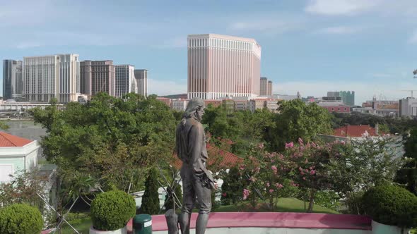 Orbit around statue in Carmel Garden Macau with casino skyline in background