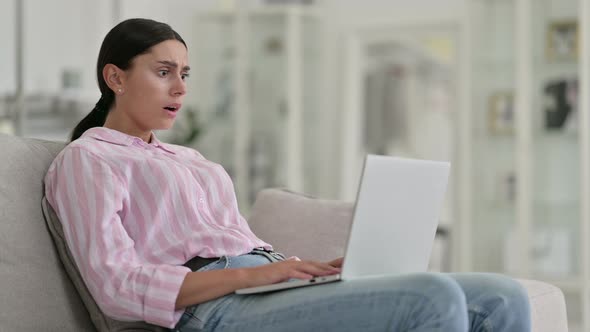 Loss, Young Latin Woman Reacting To Failure on Laptop at Home 