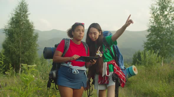 Lovely Multiethnic Female Hikers Using Gps Navigation App on Tablet Pc on Mountain Hiking