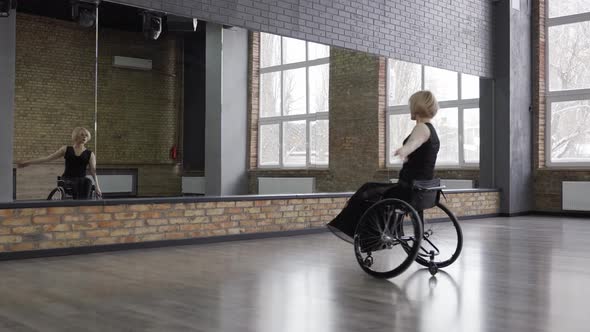 Disabled Dancer Whirling on Wheelchair in Ballroom