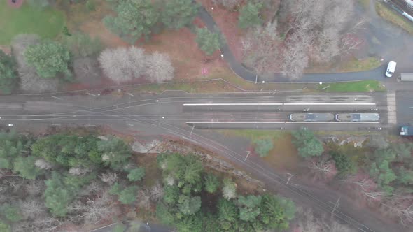 Trolley Train Standing Still Train Stop in Rural Area Top Down Sideways Aerial