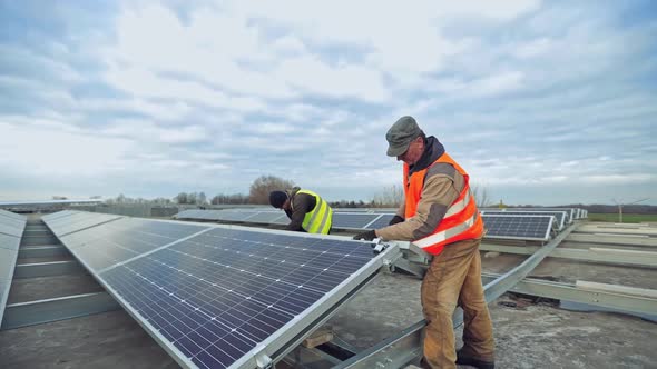 Workers Installing Solar Panels Outdoors