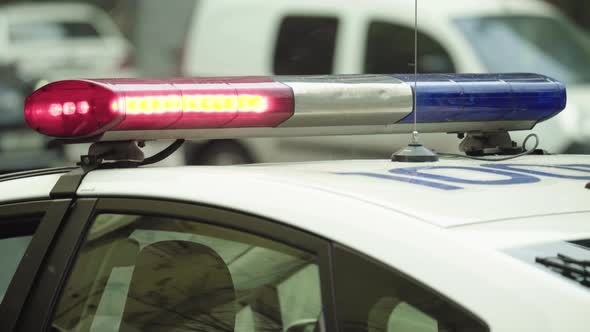 Police Flasher Flashing on the Roof of the Patrol Car