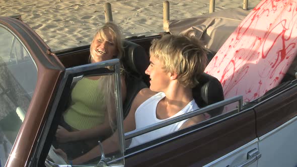 MS OF A YOUNG COUPLE SITTING IN A CAR