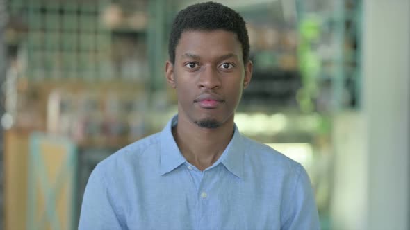 Portrait of Young African Man Looking at Camera