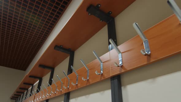 Metal Hooks on Wooden Board in Empty Locker Room of Gym