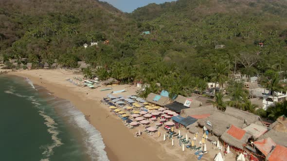 Row Of Beach Umbrellas At The Sandy Shore Of Yelapa Beach Near Puerto Vallarta In Jalisco, Mexico. A