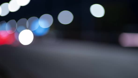 Time Lapse of Night Traffic Lights in City. Beautiful Bokeh in Dark Blurry Background at Night. UHD