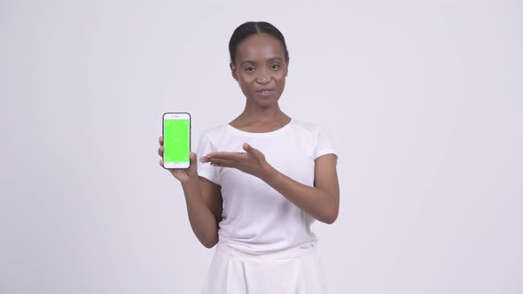 Happy Young Beautiful African Woman Showing Phone and Giving Thumbs Up