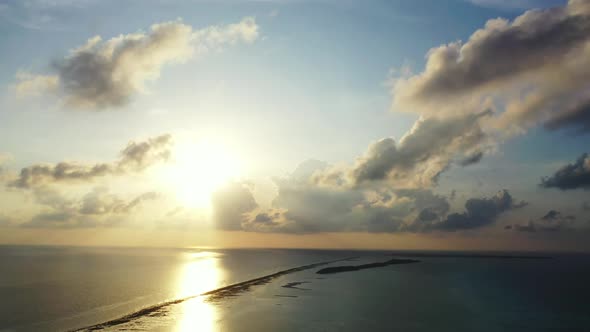 Aerial flying over texture of luxury coast beach wildlife by blue ocean with white sandy background 