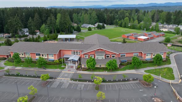 Aerial of a new elementary school with an empty parking lot.