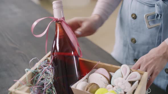 Woman Arranging Easter Gift Basket