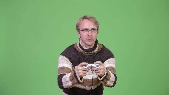 Studio Shot of Stressed Man Playing Games and Losing