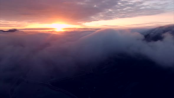 Aerial view of midnight sun above the clouds in Norway