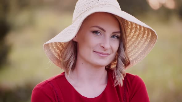 Portrait of Positive Smiling Woman Looking Into Camera at Sunset