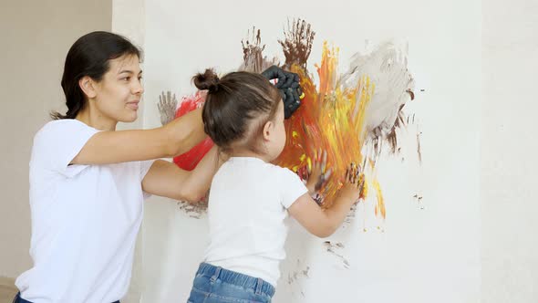 Mom Adds Paints on Canvas and Little Daughter Smudges