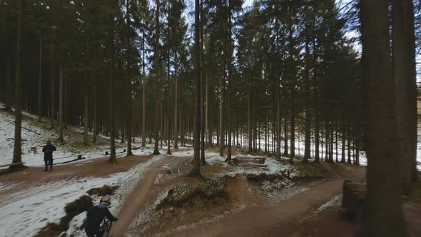 Drone Flight Following Cyclist Jumping Forest Paths