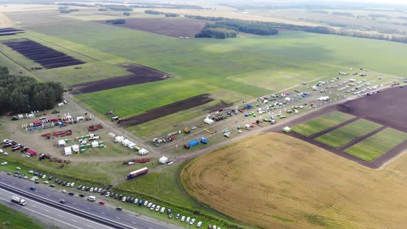 Aerial View of Green Field Where Harvest is Being Harvested