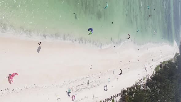 Vertical Video Kitesurfing Near the Shore of Zanzibar Tanzania Aerial View