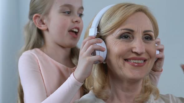 Granny Listening in Earphones Favourite Music of Granddaughter, Common Interests