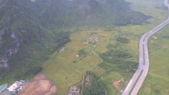 Tiny Village Surrounded By Fields at Hill Range Foot