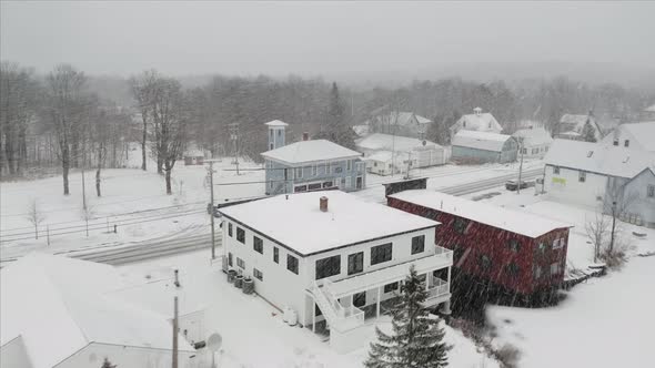 Snowfall over small town aerial 4K