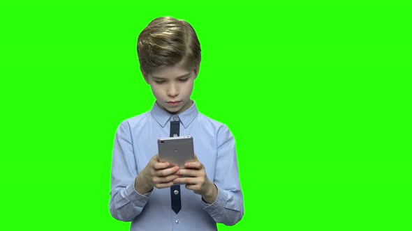 Portrait of Kid Enthusiastically Playing Games on Mobile Phone