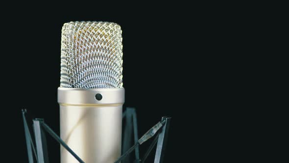 Studio Microphone with Spider Rotates on a Black Background