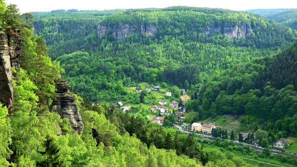 A Village Enclosed with a Forest and Rocks - Top View