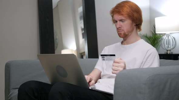 Online Shopping on Laptop by Sitting Redhead Man