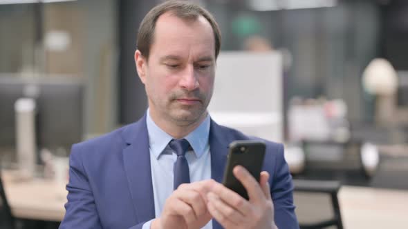 Portrait of Businessman Using Smartphone