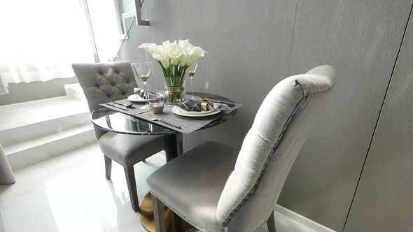 Decorated Rounded Glass Coffee table with Elegant Silver Chairs