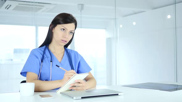 Doctor Writing Medicine for Patient, Sitting in Front