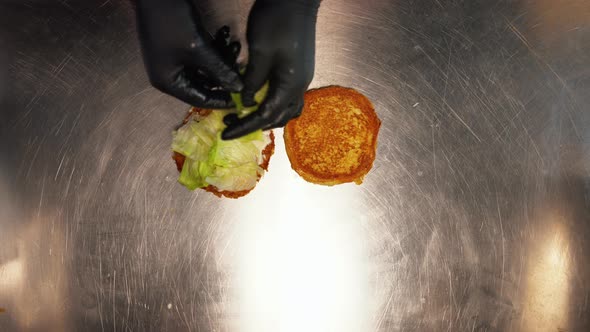 Top Down View of Fast Food Worker Making a Burger