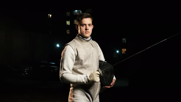 Portrait Of Young Fencer Man Looking Into Camera On The Street.