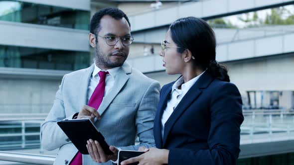 Smiling Coworkers with Digital Devices