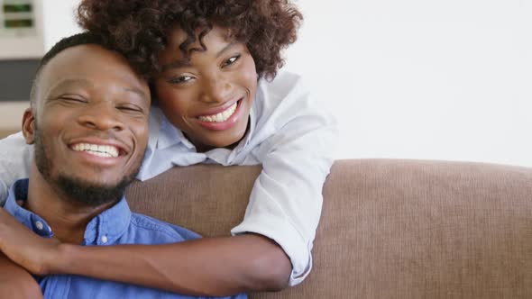 Woman embracing man in living room