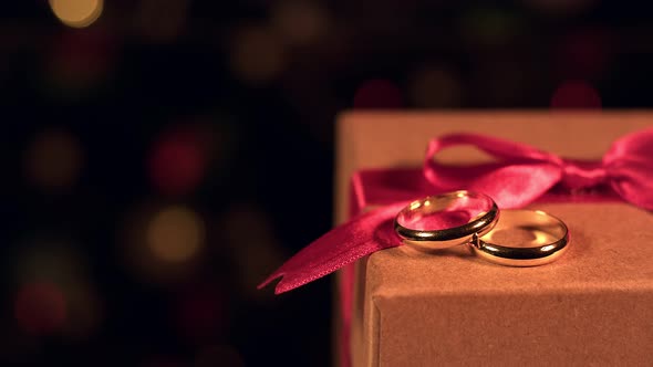 Gift Box Colorful Bokeh And Shiny Wedding Rings