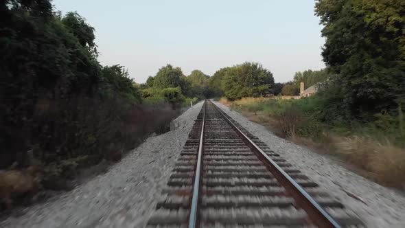 Drone flying Low over Railroad Tracks near Sunset