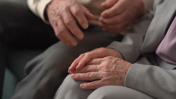 Hand of an Elderly Woman Holding the Hand of an Elderly Man