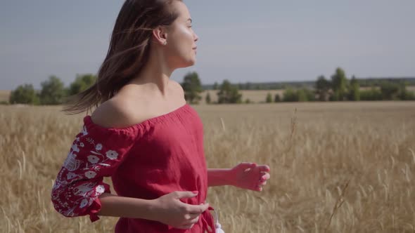 Side View of Beautiful Carefree Woman with Long Hair Running Through the Wheat Field, Hair