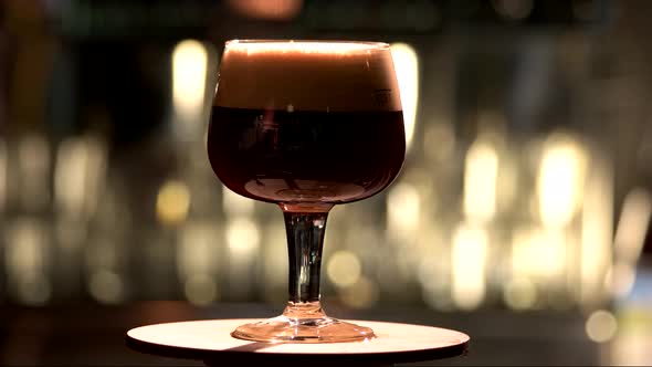 Snifter Glass with Black Stout Beer Exposition