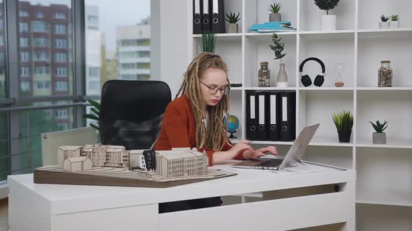 Female Architect with Dreadlocks Working at Laptop in Design Office Agency