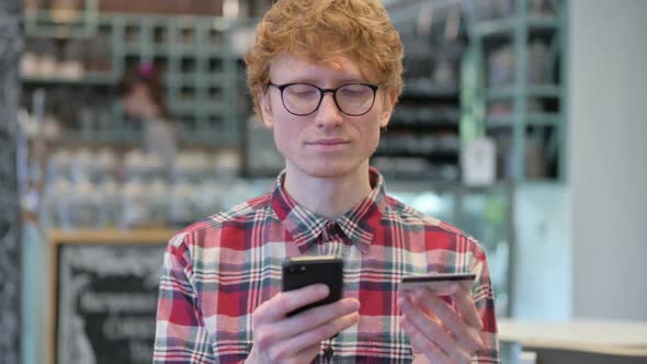 Online Shopping Success on Smartphone By Redhead Man