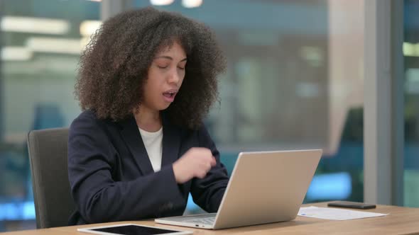 African Businesswoman with Laptop Coughing