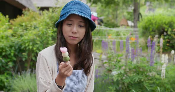 Woman having japanese dango in japanese traditional house