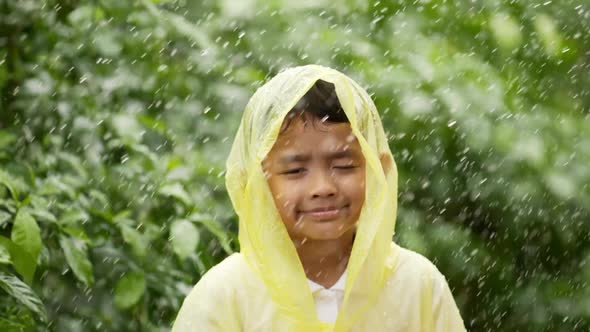 Happy boy wears raincoat